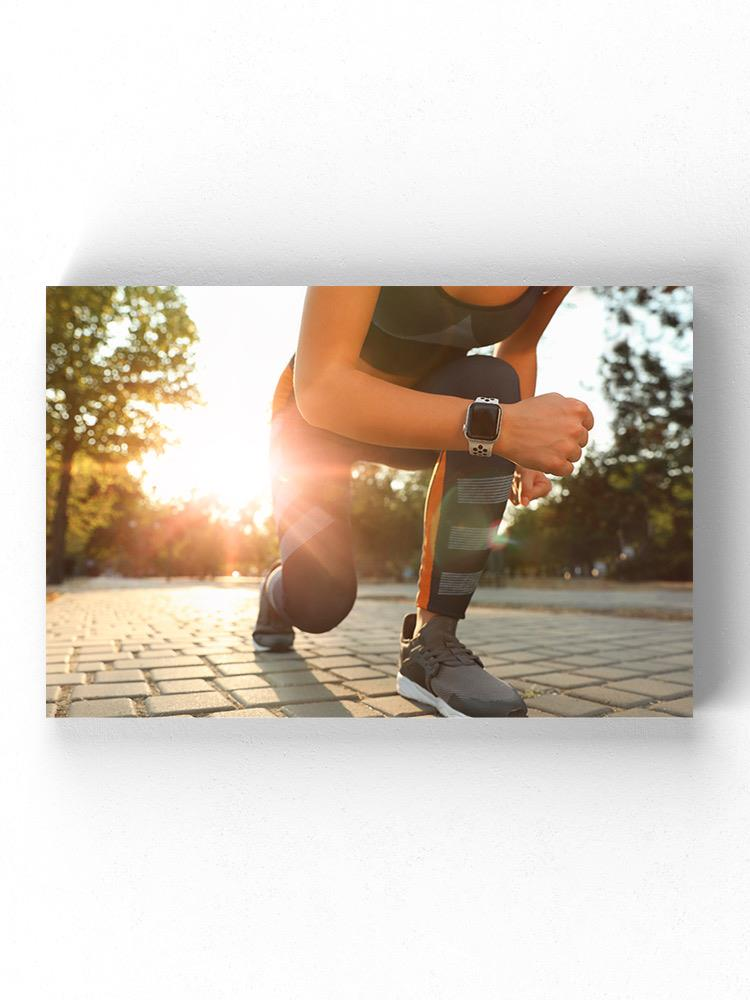 Runner Woman Getting Ready Wrapped Canvas -Image by Shutterstock